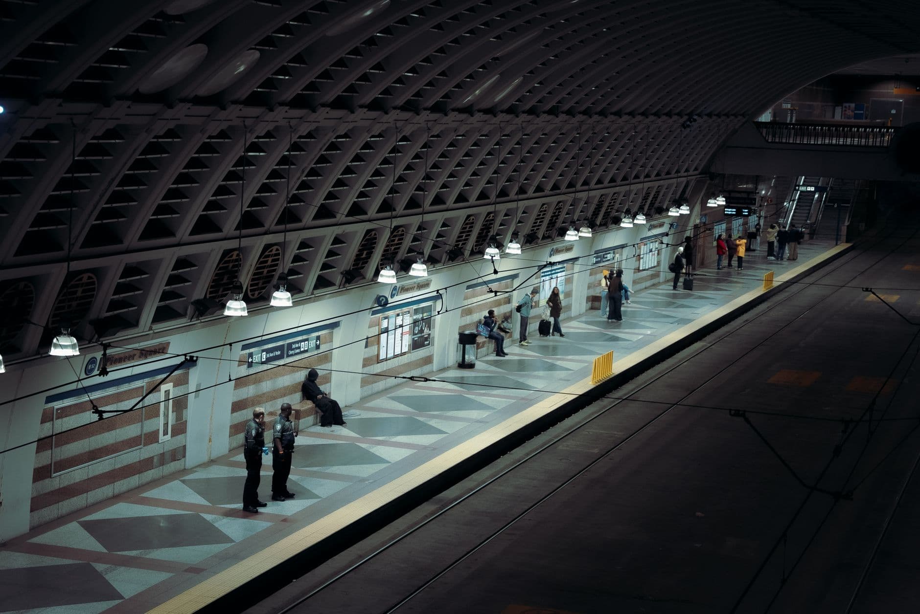 Seattle subway station platform with people waiting at night