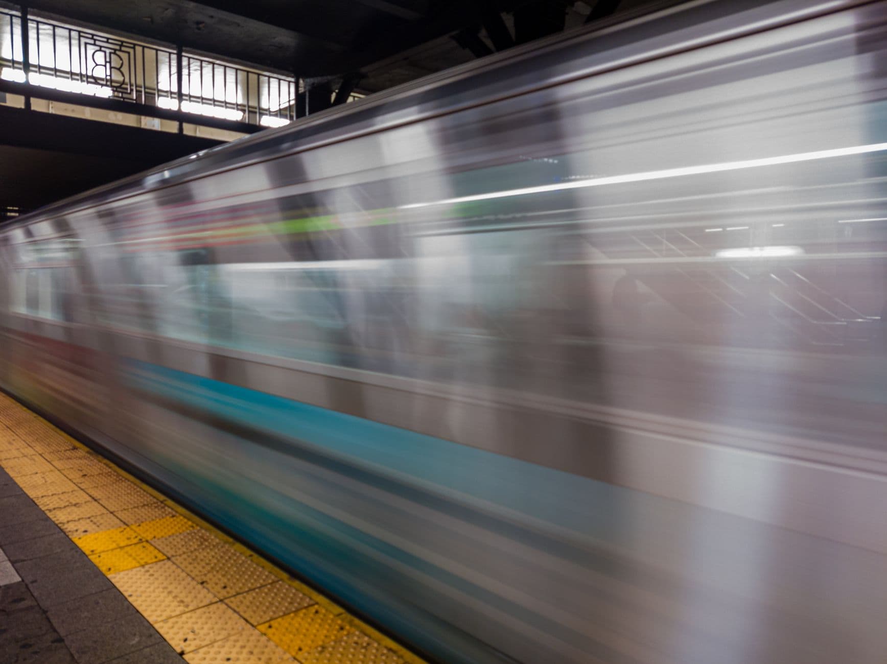 Dynamic capture of a fast-moving subway train in NYC, showcasing urban transit motion.